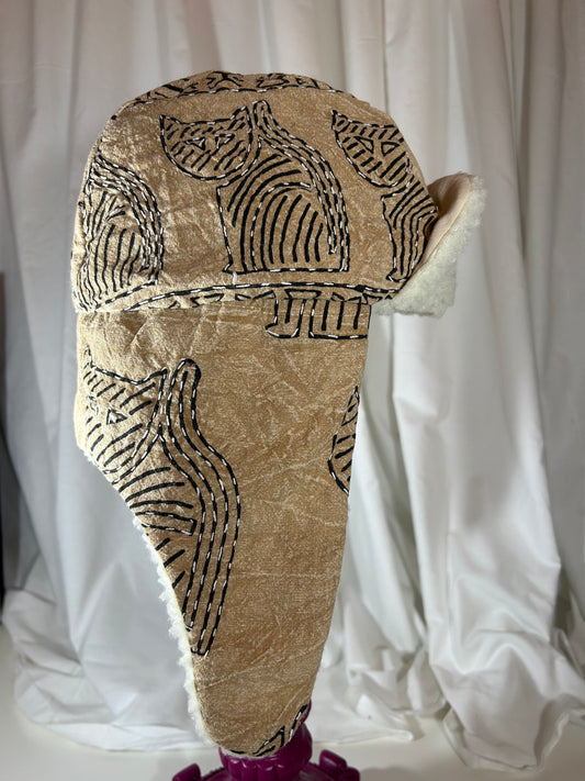 textured beige hat with cat line patterns